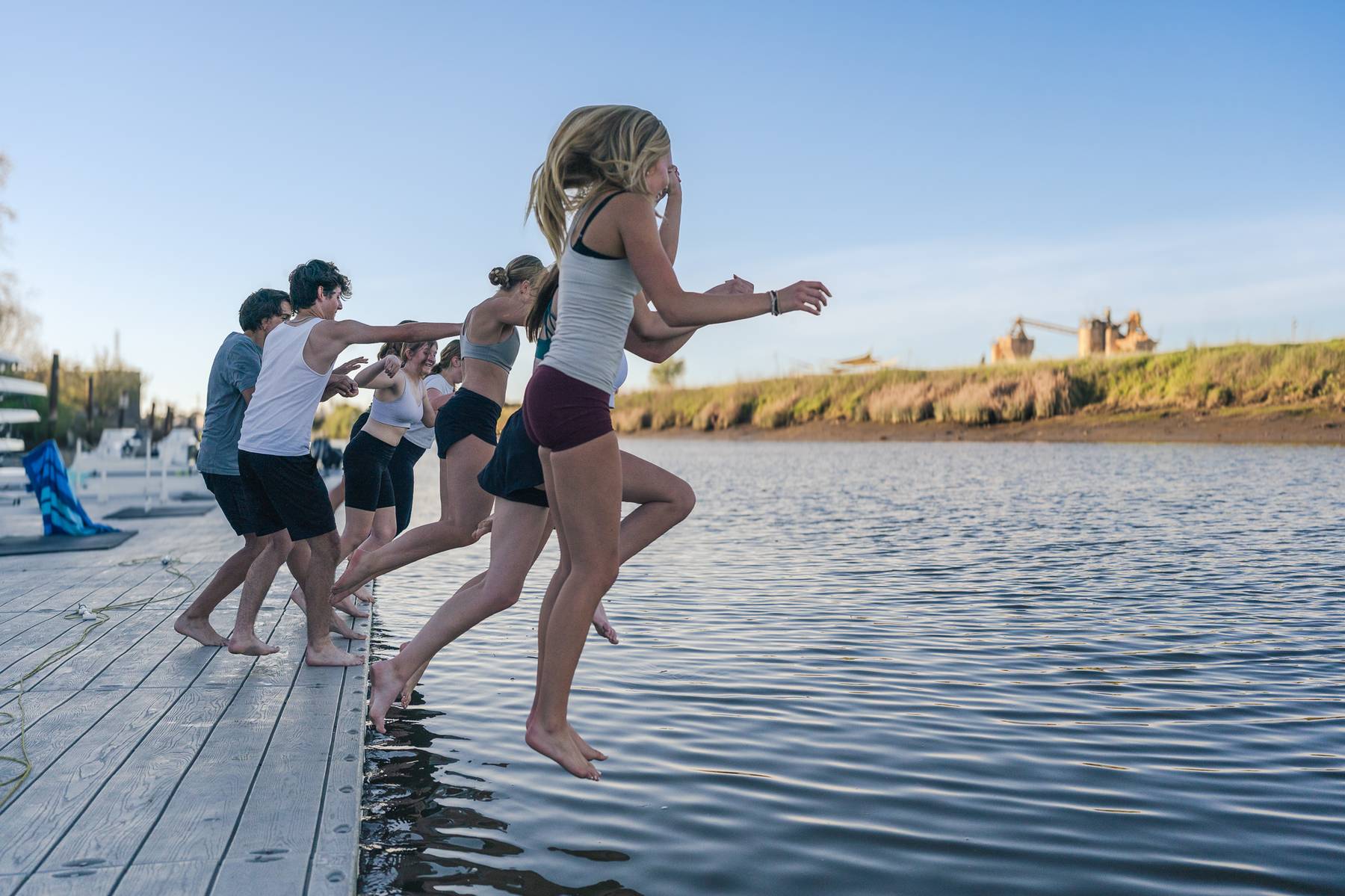Rowing team jumping into the water together
